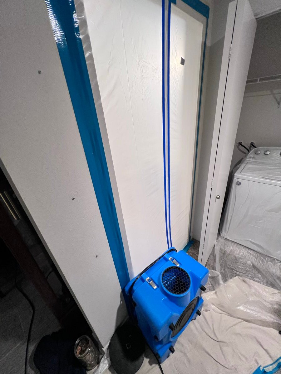 Poly containment barrier and air mover set up to control a water damage drying work area