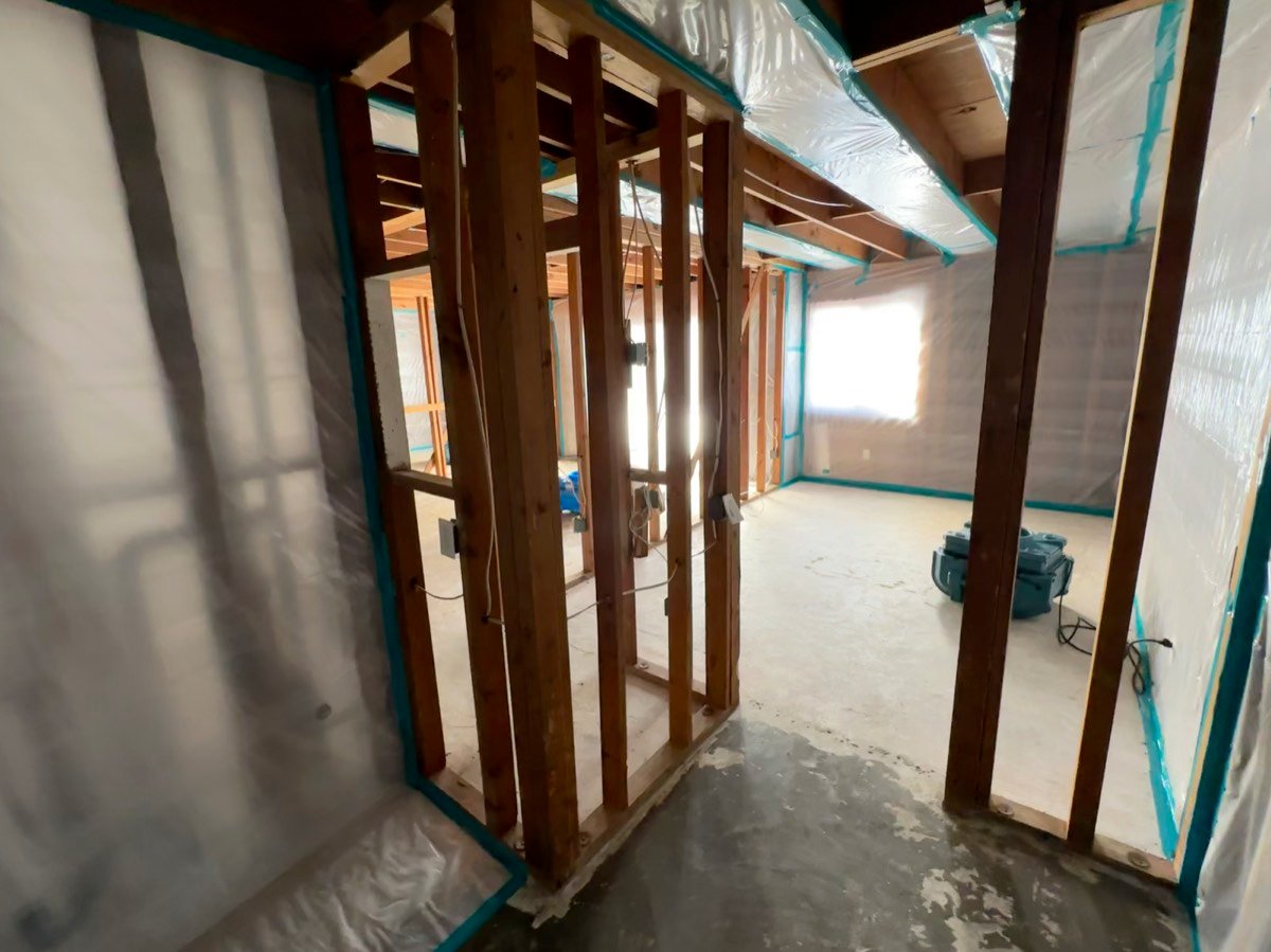 Wall framing exposed and ready for drywall reconstruction after mitigation work in San Diego